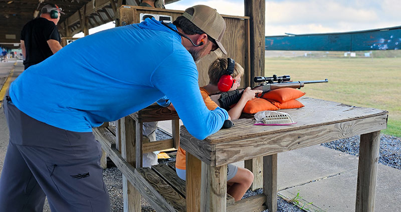 Dad at ASC teaching son about range safety.